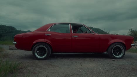 vintage red car on a country road