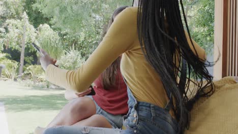 Sad-diverse-teenage-female-friends-embracing-and-using-smartphones-in-slow-motion