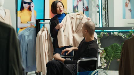 customer in wheelchair trying on clothes