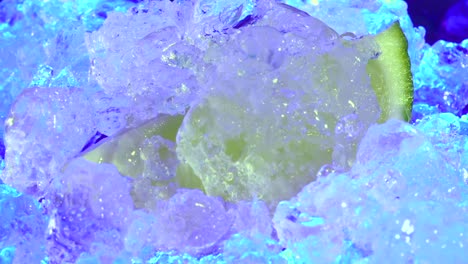 Close-up-of-defrosted-mint-sprig-is-accompanied-by-a-freshly-cut-lemon-slice,-immersed-in-ice,-embodying-the-concept-of-invigorating-refreshment,-revitalization,-and-rejuvenation-amidst-summer-heat