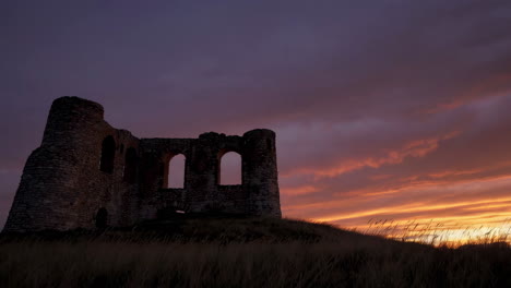 silhouette of a ruined castle at sunset