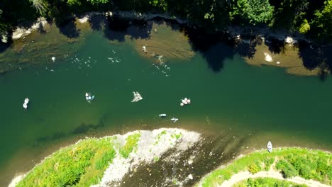 usa, or, estacada, clackamas river, 2024-07-14 - flying over the clackamas river at milo mciver state park. people are seen floating down the river. direct stationary overhead shot