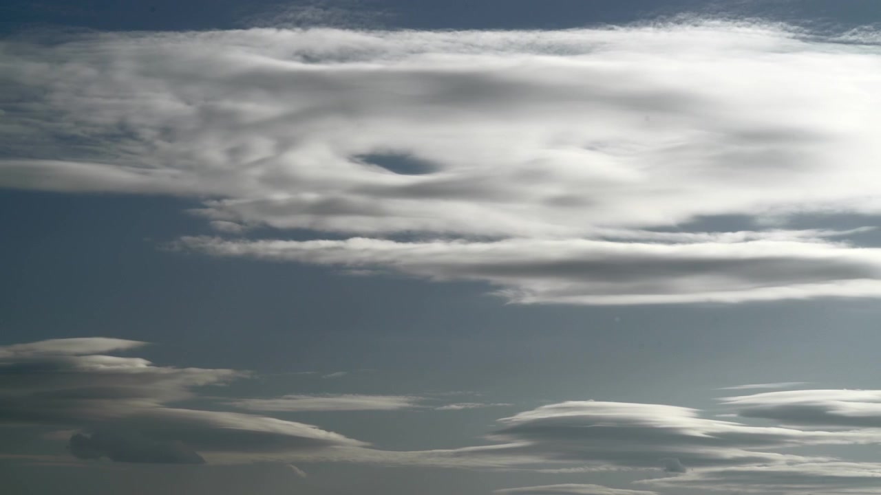 Time Lapse of Lenticular Clouds Moving Across a Clear Blue Sky