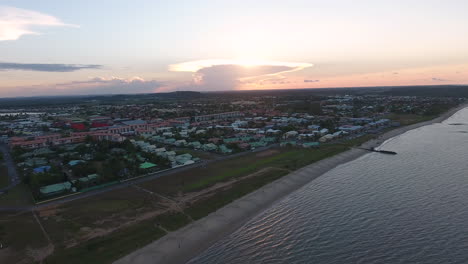 sand football field along a beach on kourou coastline. aerial view sunset