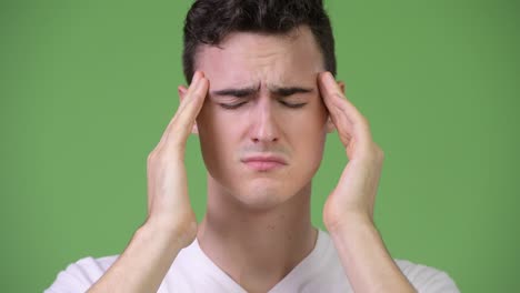 young handsome man having headache