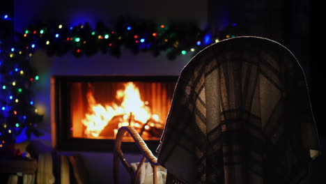 A-Rocking-Chair-Stands-In-Front-Of-A-Fireplace-Decorated-For-Christmas-And-New-Year-4k-Video