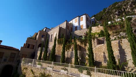 Beautiful-resort-with-stone-walls-on-hills-above-shoreline-of-Ionian-sea-in-Albania,-famous-luxury-hotel-for-summer-vacation