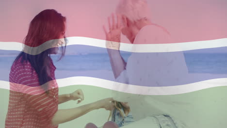 thai flag animation over two people sitting on beach