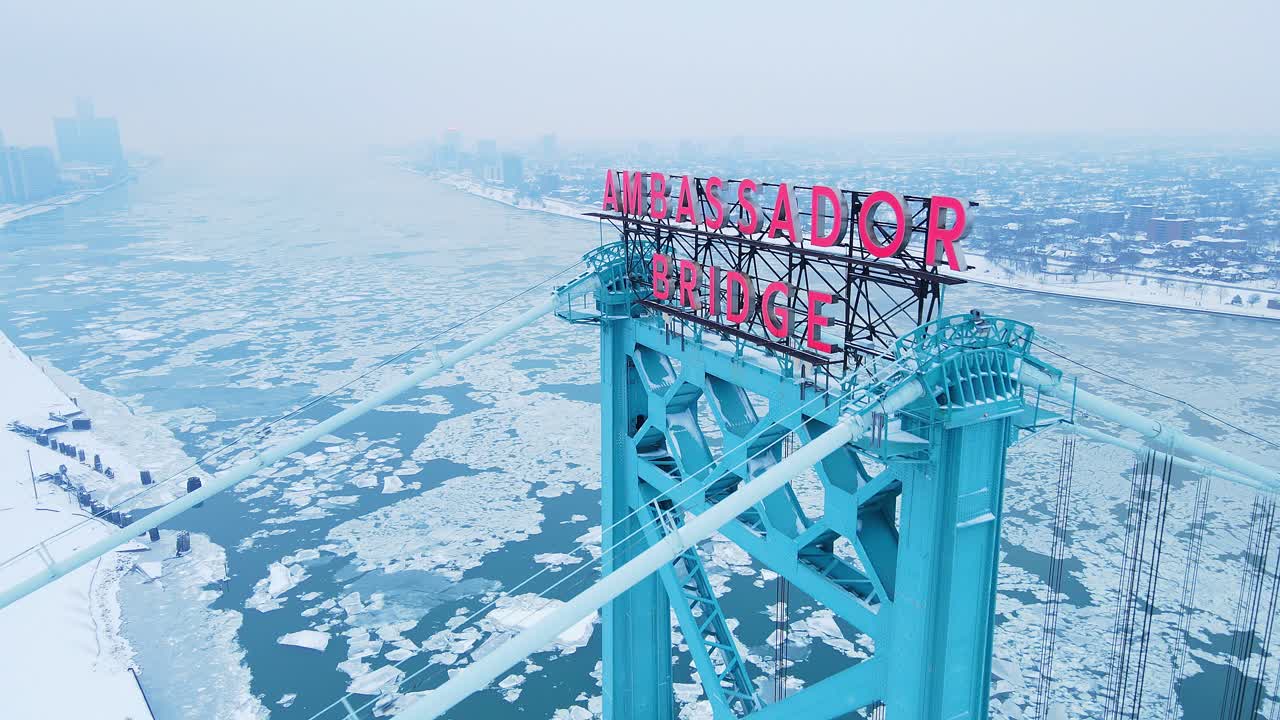Ambassador Bridge in winter with frozen river with Detroit and Windsor skyline