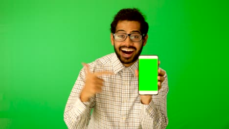 guy-using-mobile---tablet-with-green-screen-and-green-background-indian-guy-with-green-screen