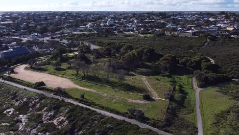 Orbit-View-Of-Old-Quinns-Rocks-Caravan-Park-Site-Perth-And-Nature-Reserve,-With-Houses-Surrounding