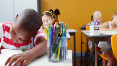 school kids doing homework in classroom
