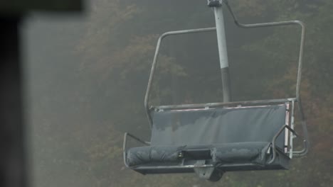 Dramatic-revealing-close-up-shot-of-old-abandoned-rusty-chairlift