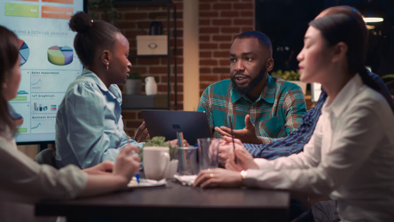 Business meeting, analytics specialist showing data on laptop screen