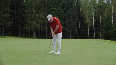 man playing golf on a putting green