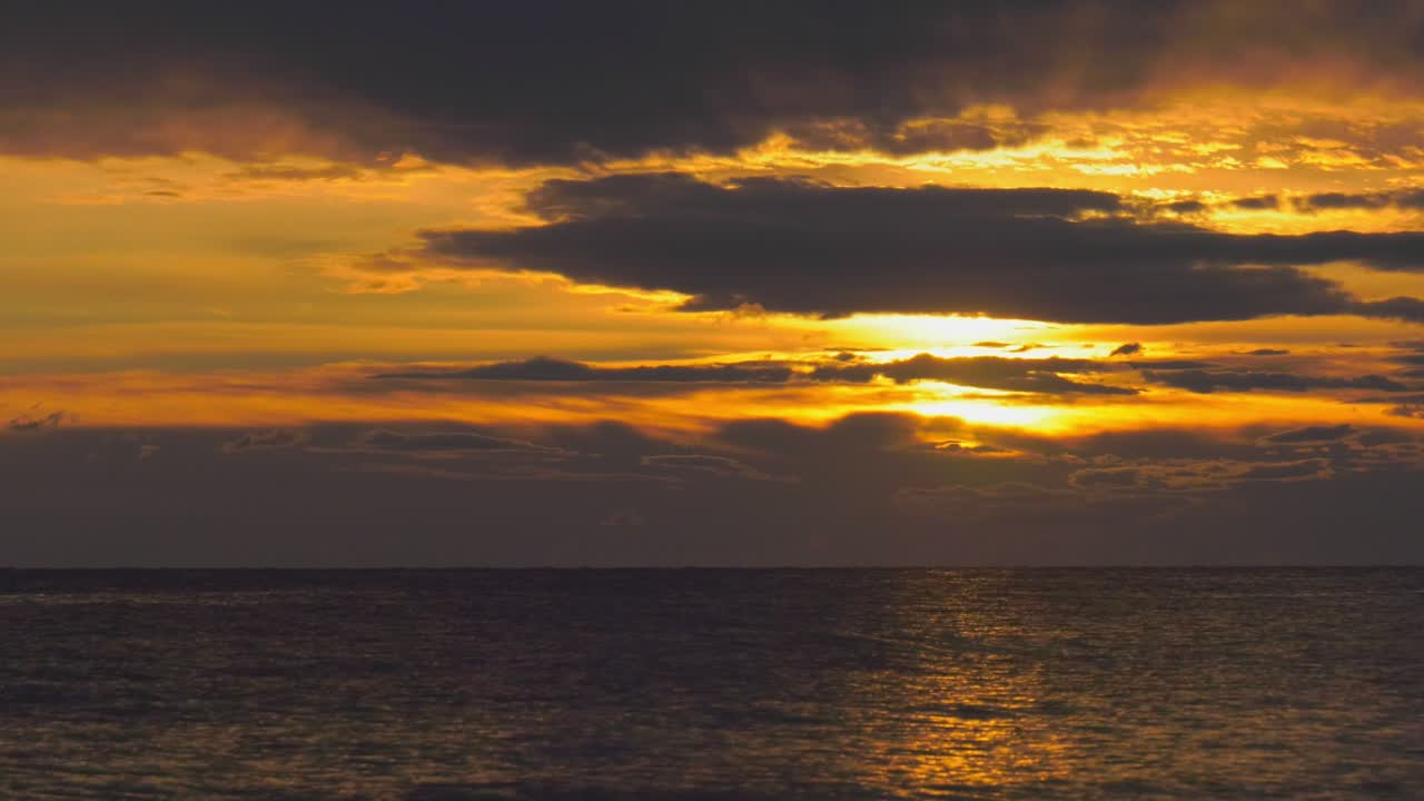Ocean sunrise with dramatic clouds in dawn sky