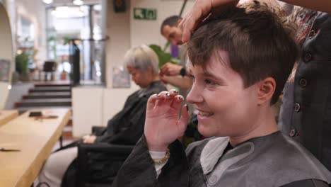 woman getting haircut at salon