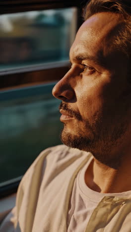 thoughtful man gazing out of a window