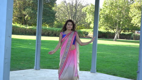 Joven-Hermosa-Mujer-Vestida-Con-Ropa-India-Tradicional,-Bailando-Al-Aire-Libre