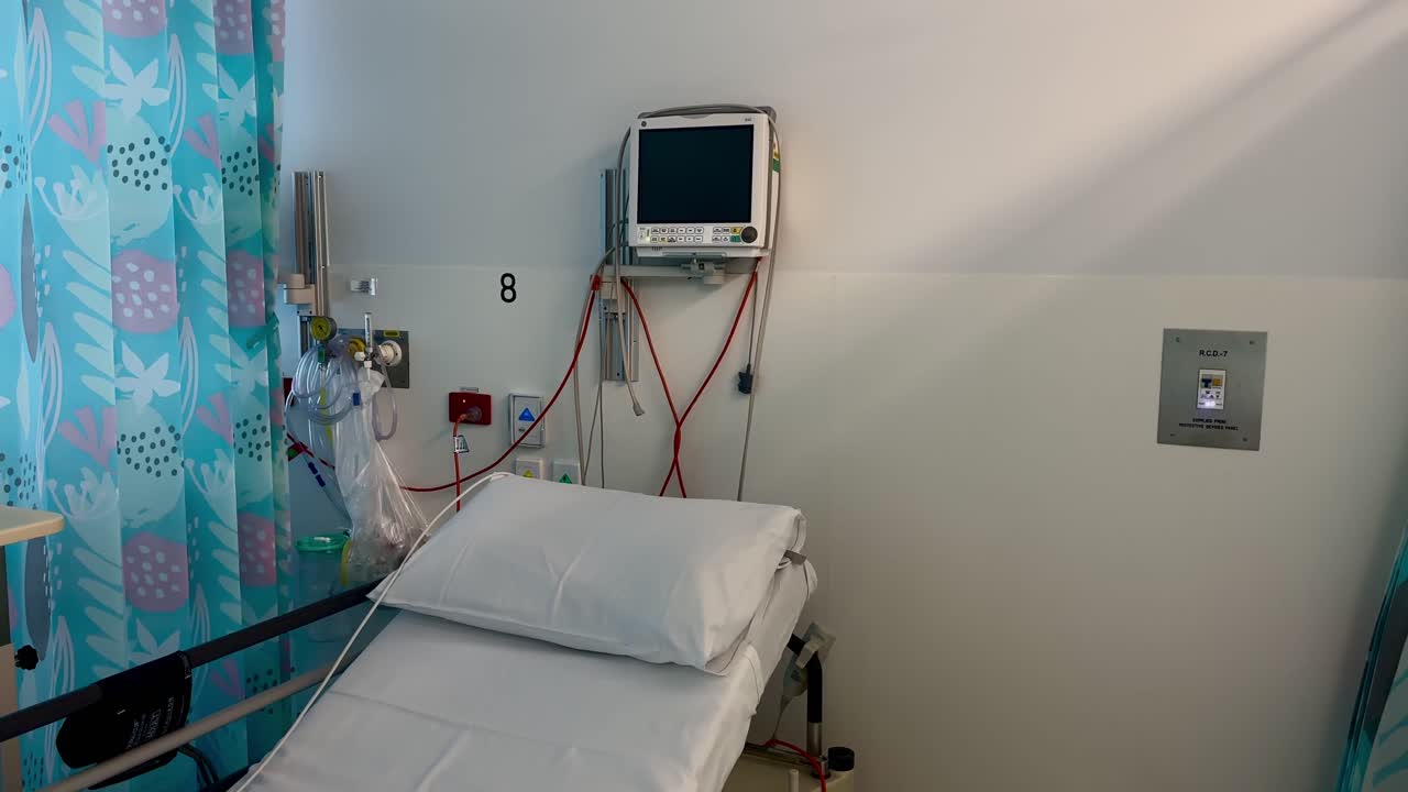 Wide empty hospital bed medical ward blank wall Perth Western Australia