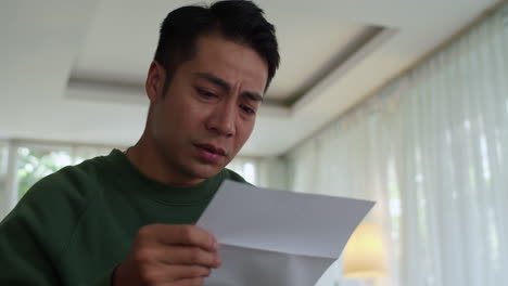 sad man reading letter