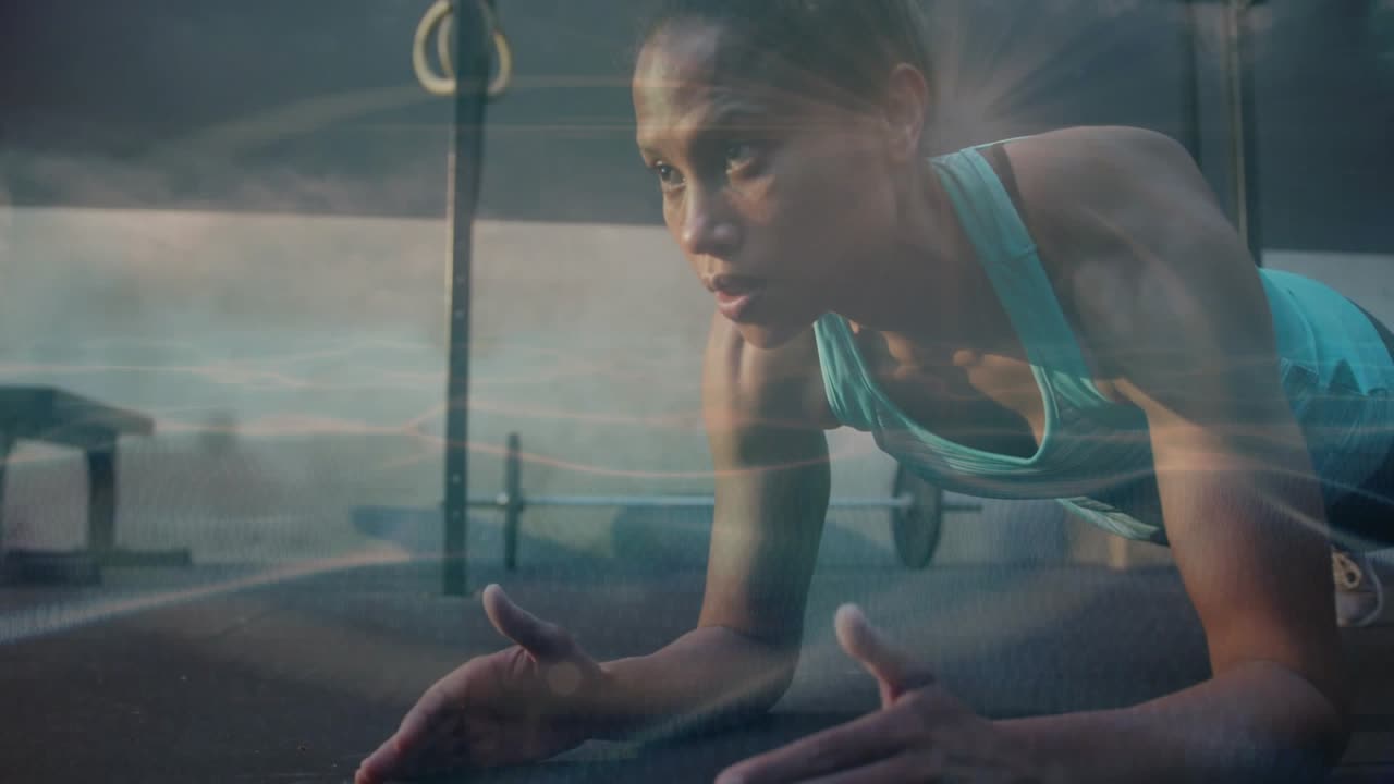 Cam panning up woman holding forearm plank on mat fitness gear visible light streaks boosting core