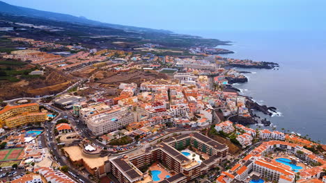 urban area on the rocky coast of the atlantic ocean. drone footage over the scenery of tenerife island, spain