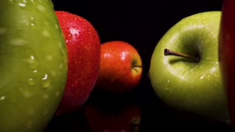 forwards fast moving macro view past apples with black isolated background, stunning footage of heatly fruit