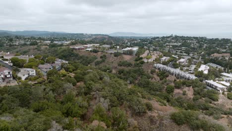 Drone-Flying-Over-Residential-Area,-Contrast-Of-Traditional-Cottages-And-New-Buildings,-San-Mateo