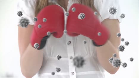 animation of virus cells floating over midsection of caucasian female boxing