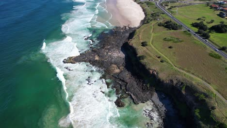 tilt-up reveal of sharpes beach next to white's head and flat rock in ballina, nsw, australia