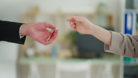 real estate agent hands over keys to new apartment