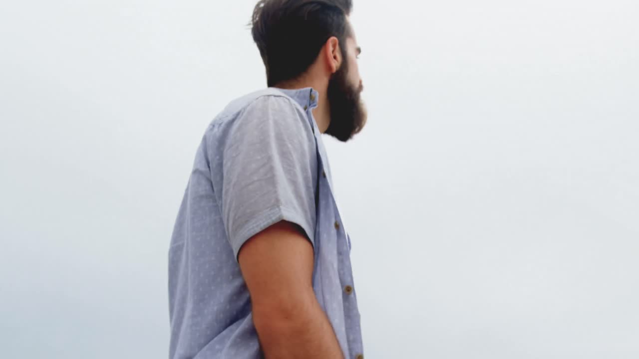 Side view of Caucasian couple walking hand in hand on the beach 4k