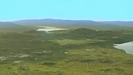 two-ponds-on-the-mountain,-with-swamp-area-and-skies-in-the-background