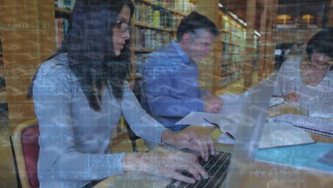 Animation-of-binary-code-over-multiracial-students-studying-while-sitting-in-library