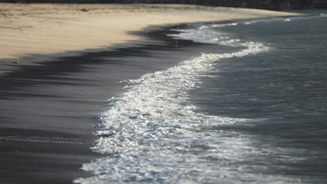 waves gently roll onto the sandy beach