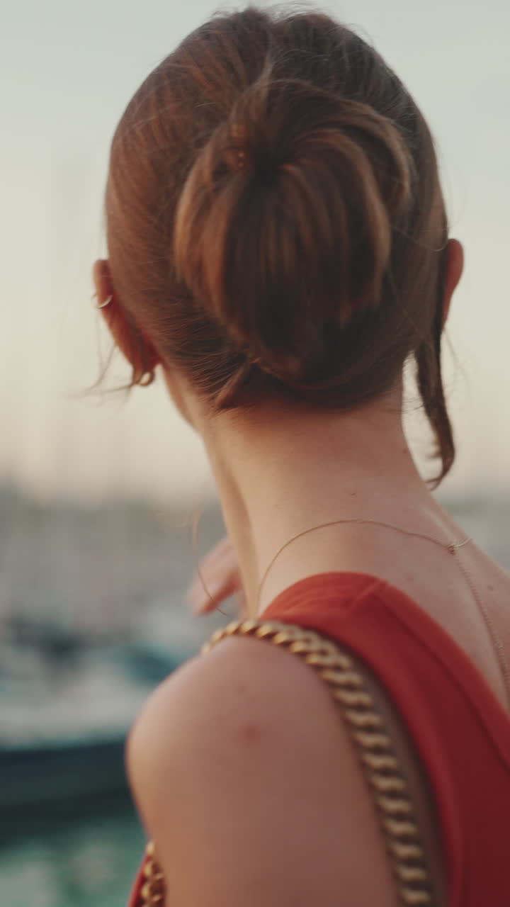 Woman with hair bun and gold chain