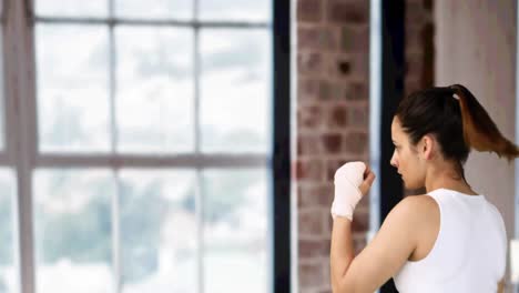 Animation-of-woman-boxing-against-modern-gym-interiors