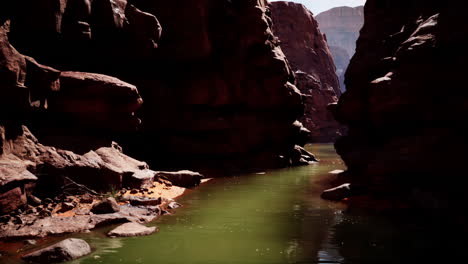 a narrow canyon with a river flowing through it