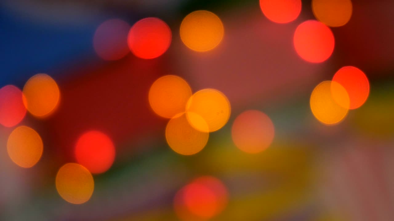Blurred colorful lights. Red, green, yellow, orange, blue defocused glittering bokeh festive background.