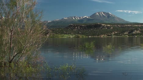 mediumshot of the recapture lake in utah and the san juan mountain