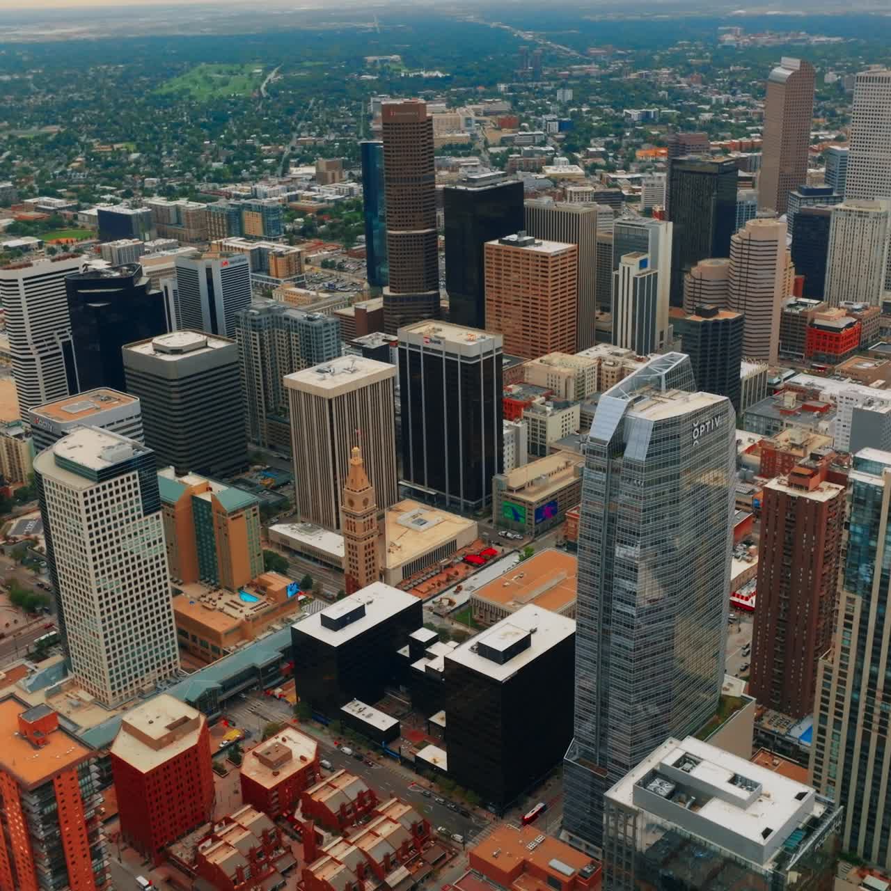 Denver skyscrapers at backdrop of green cityscape. Beautiful city architecture from aerial perspective at daytime