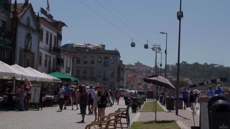 crowded street scene in porto, portugal with cable car