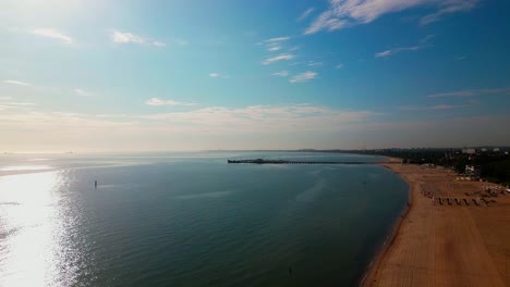 Morning sunlight over calm seaside holiday beach resort AERIAL