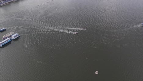 aerial footage of a ferry and a speedboat heading to the buddha statue of hyderabad at hussain sagar lake the statue was carved out of granite rock