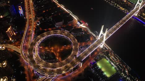 aerial video scene of traffic on nanpu bridge spiral road night sunset time with transportation on land concept, shanghai, china in 4k video