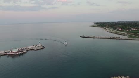 Aerial-shot-of-the-quay-and-sailing-motor-boat