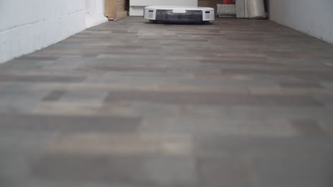 smart home. robot vacuum cleaner performs automatic cleaning of the apartment at a certain time. smart helper at home. a modern robotic cleaner wipe dust on the floor. cleaning technology