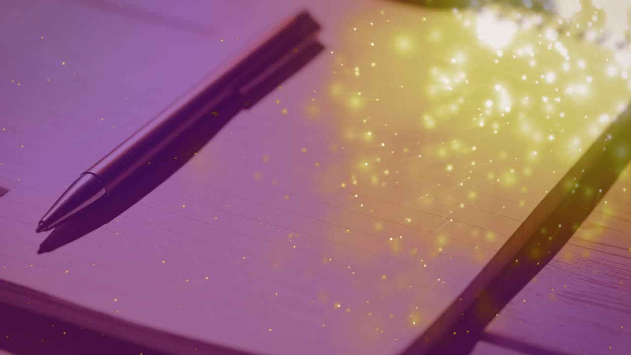 animación de chispas sobre el bloc de notas y el bolígrafo