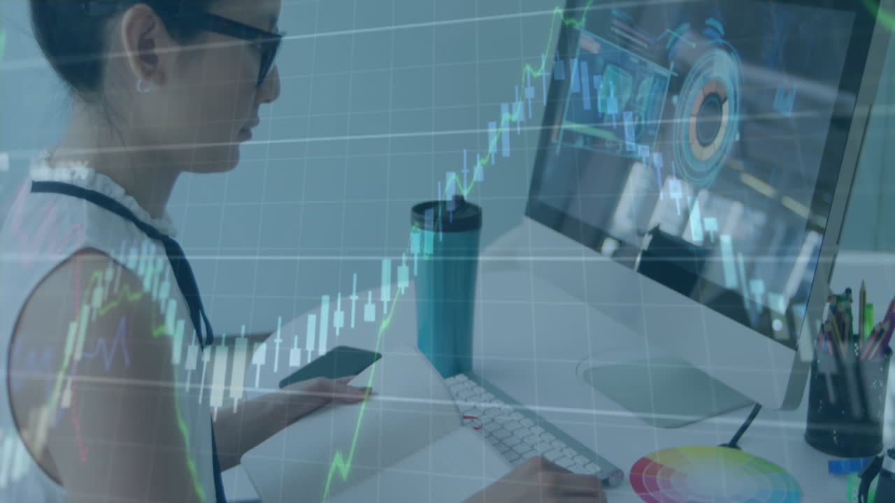 Animation of graphs with numbers over caucasian woman watching video on laptop and writing in book